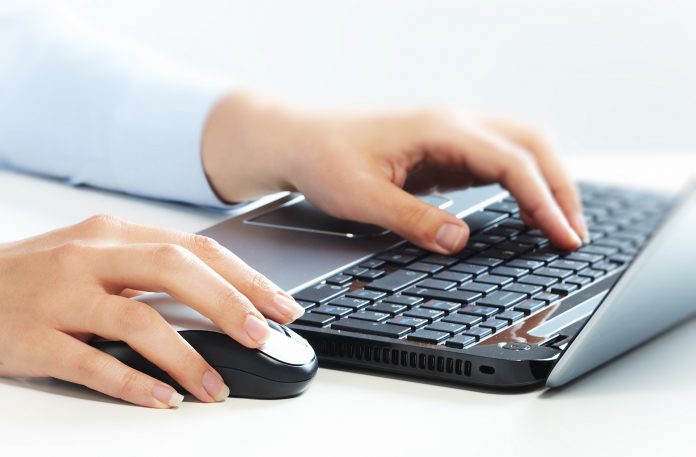 Hands with laptop computer keyboard.